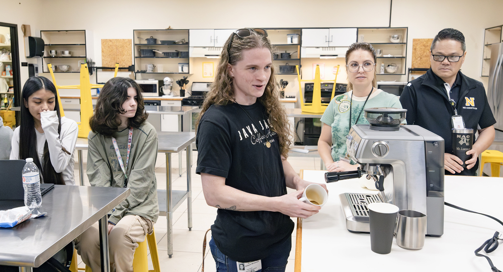 Barista trainer demonstrates espresso machine to culinary students