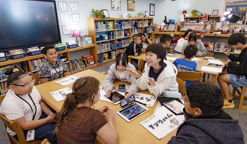 Students sitting around a table in the library