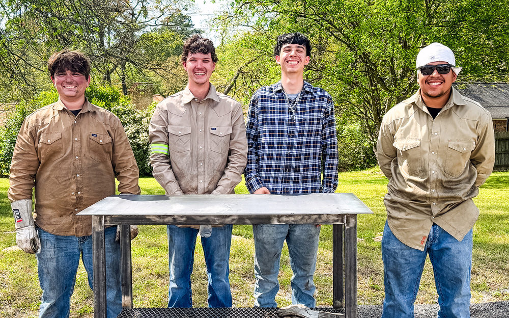 Dragon welding team standing with their project