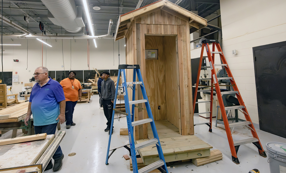 Students and teacher in construction and carpentry class