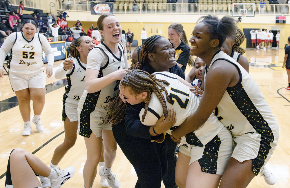 Lady Dragon basketball players celebrating win