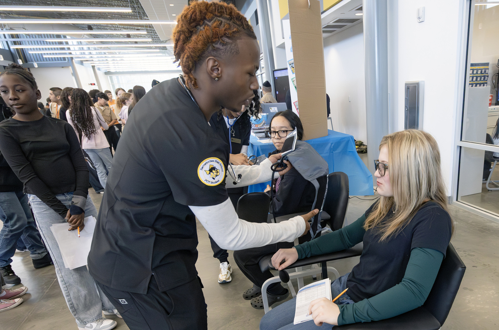 Student measures blood pressure on another student