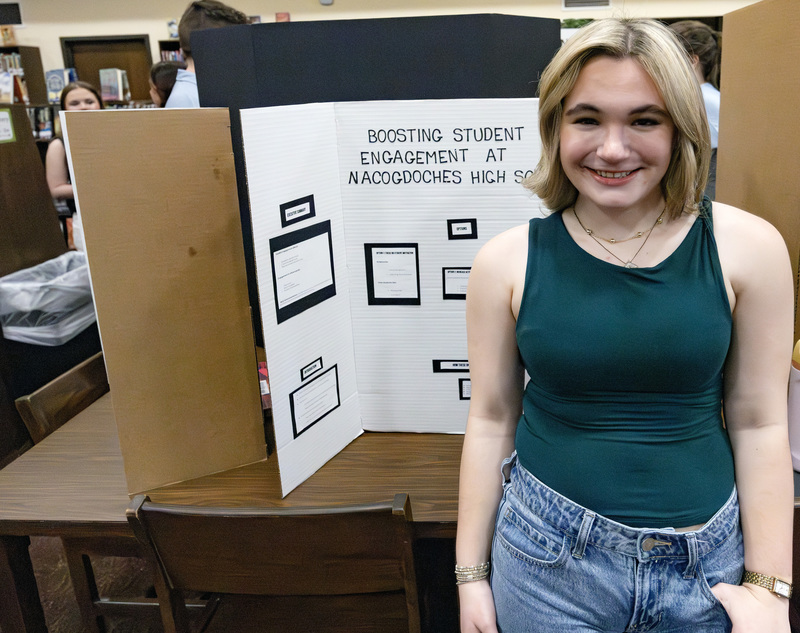 Student in front of project