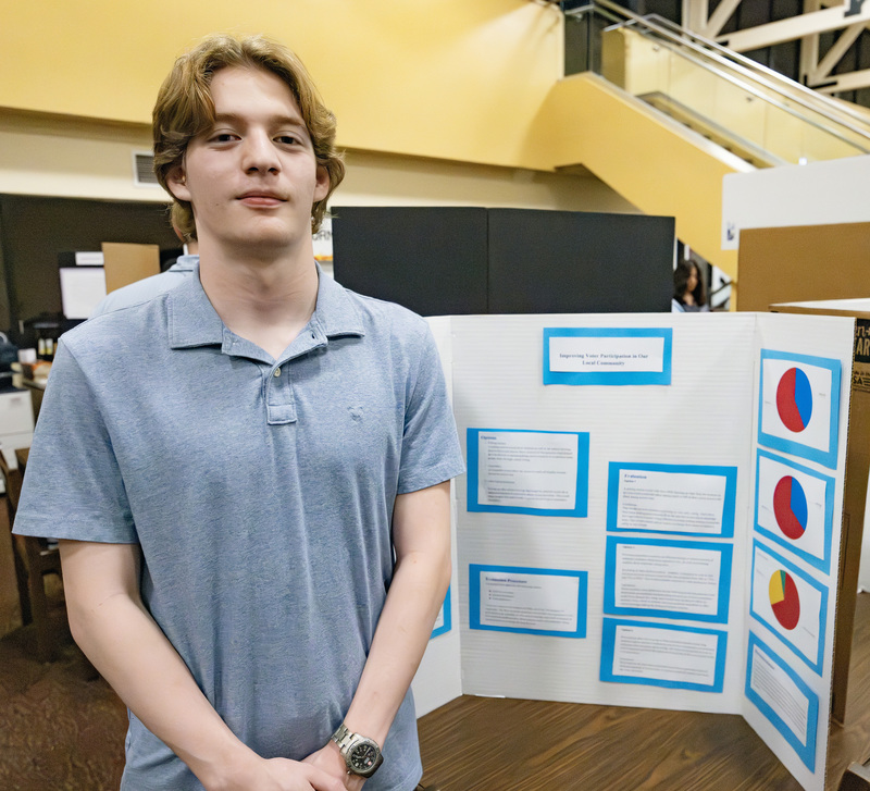 Student in front of project