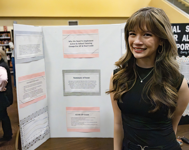 Student in front of project