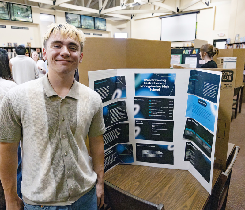 Student in front of project