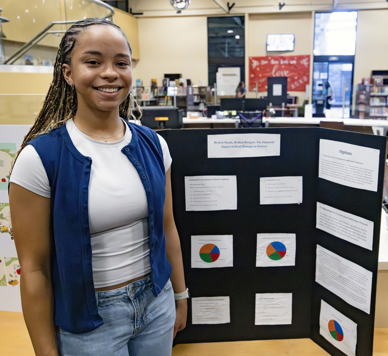 Student in front of project