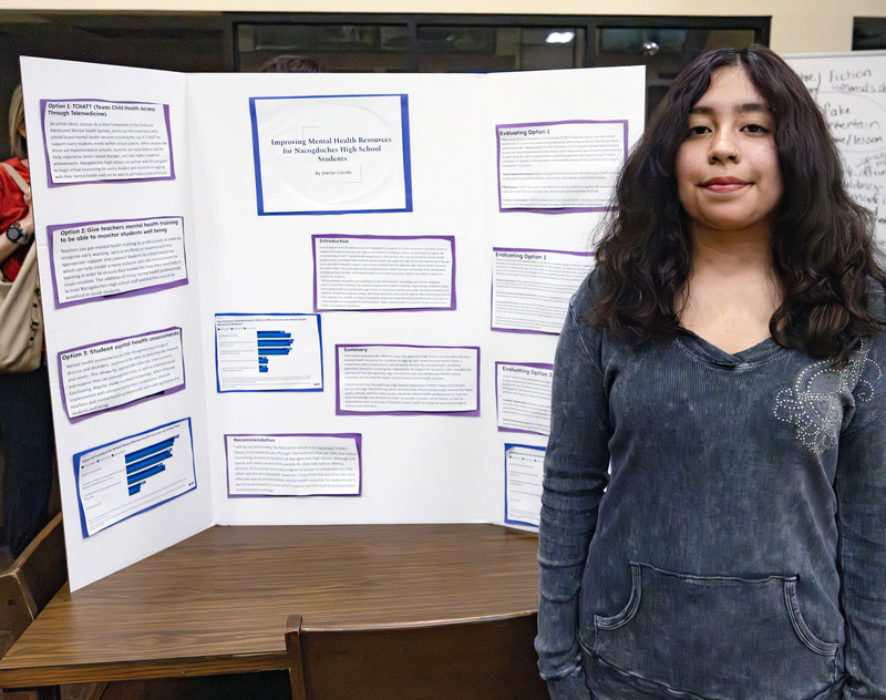 Student in front of project