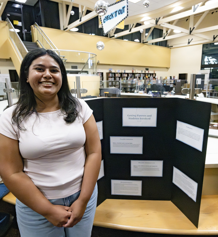 Student in front of project