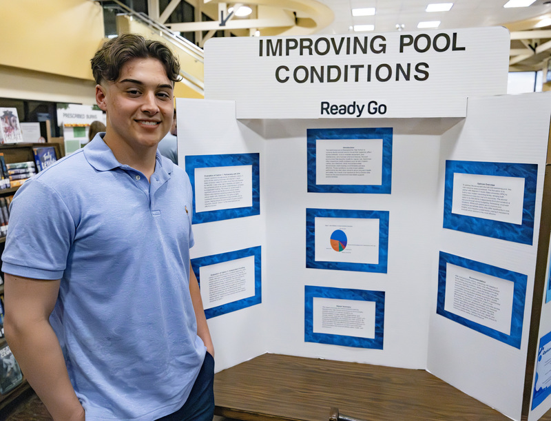 Student in front of project