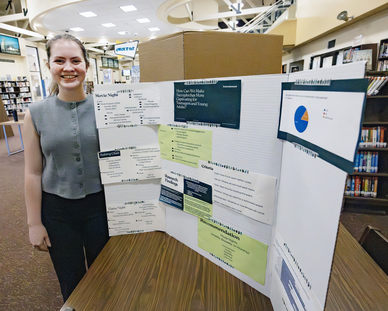 Student in front of project