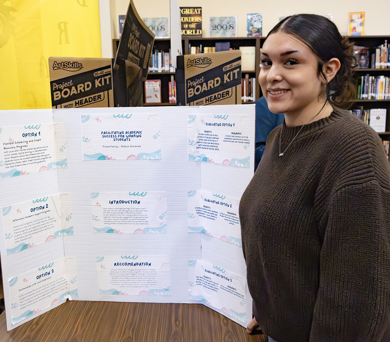 Student in front of project