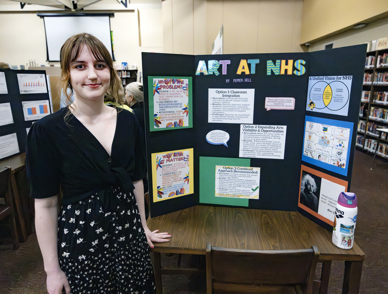 Student in front of project