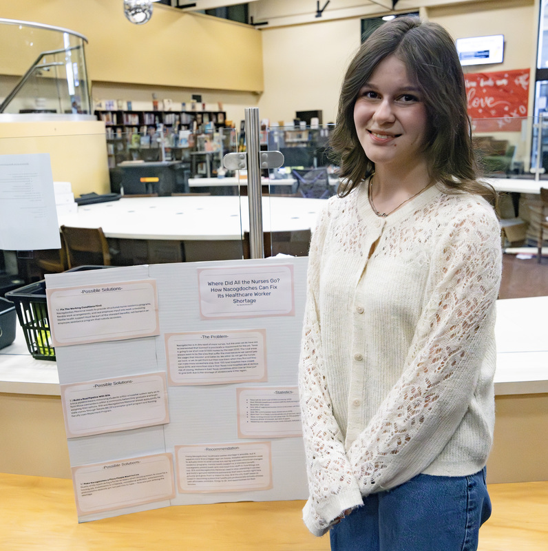 Student in front of project