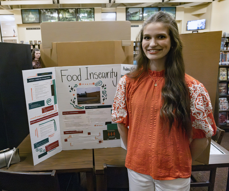 Student in front of project