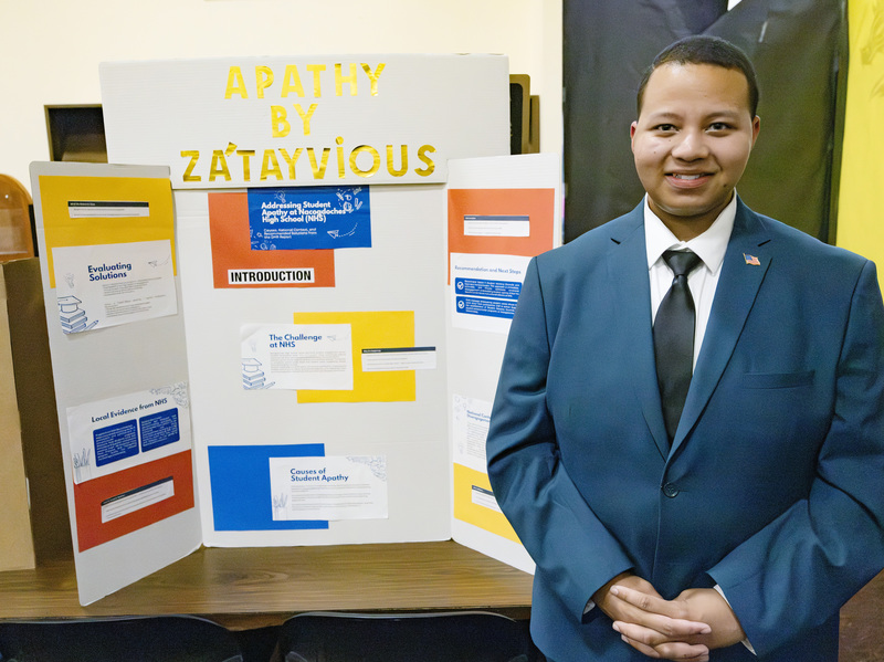 Student in front of project