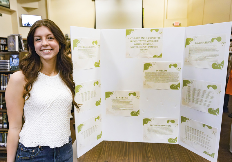 Student in front of project