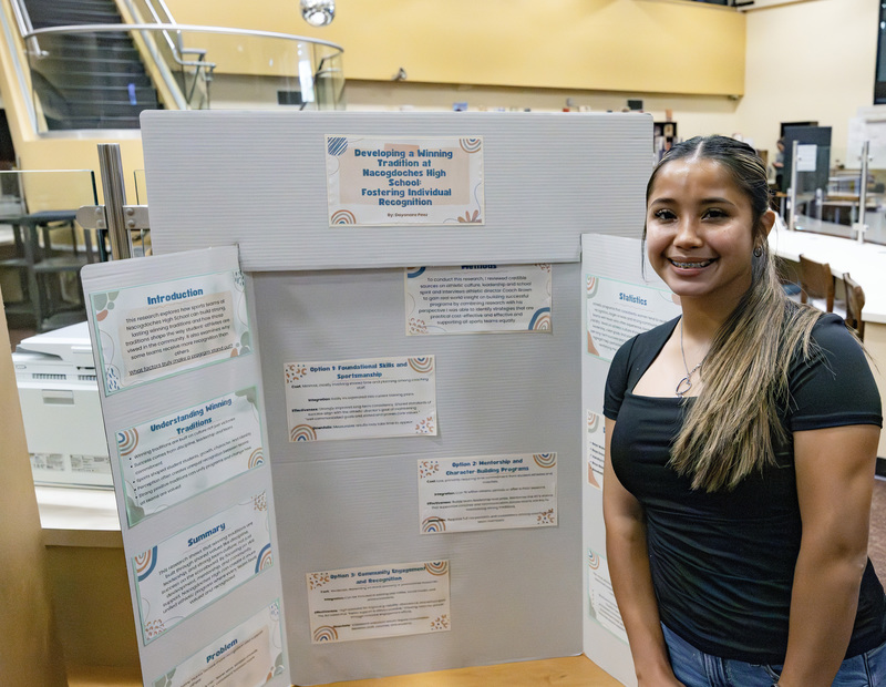 Student in front of project