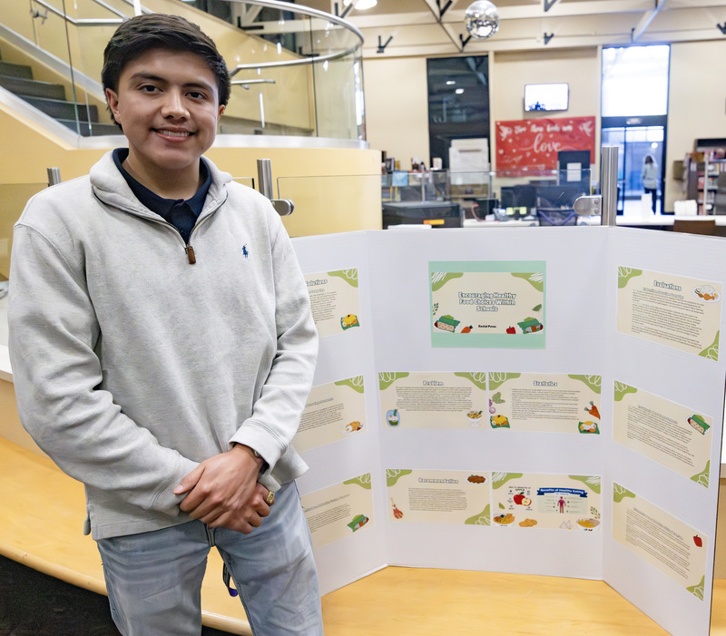 Student in front of project