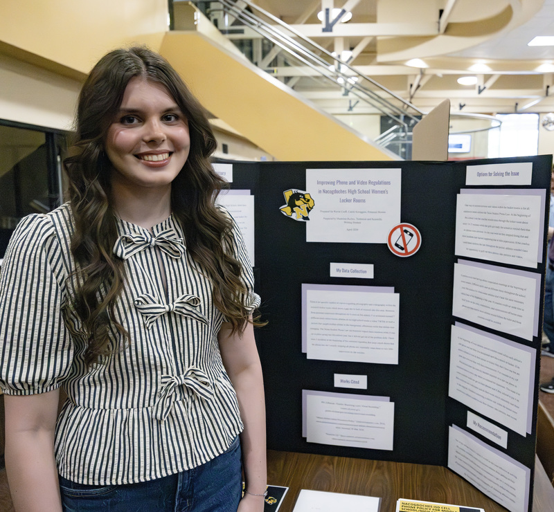 Student in front of project