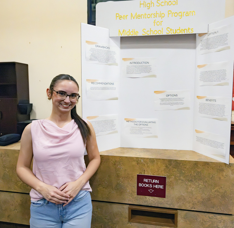 Student in front of project