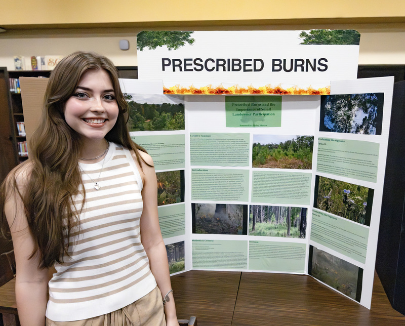 Student in front of project