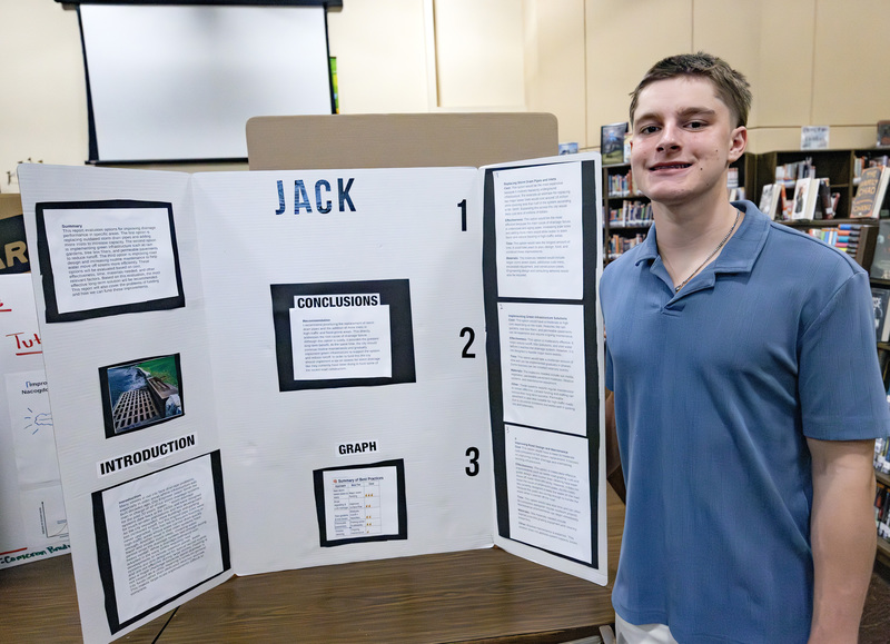 Student in front of project