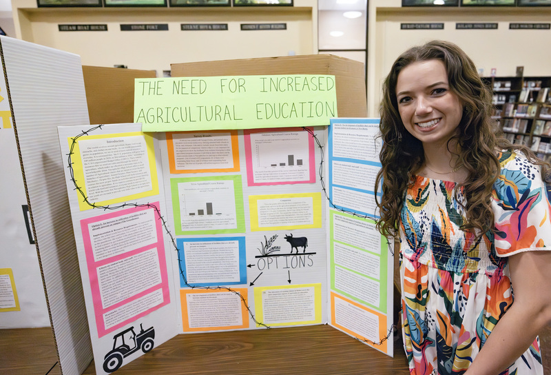 Student in front of project