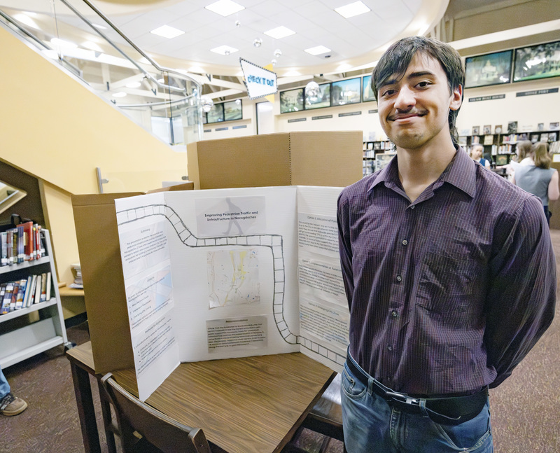 Student in front of project