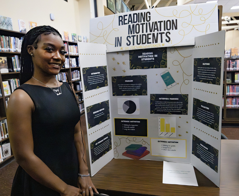 Student in front of project