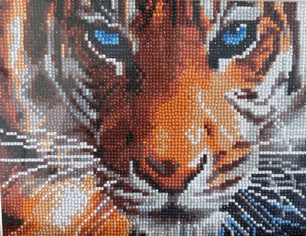 An artistic portrait of a tiger made from beads