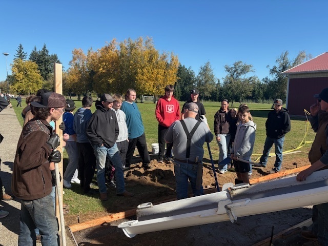 Napavine Students learning how to pour cement and make a sidewalk behind the high school
