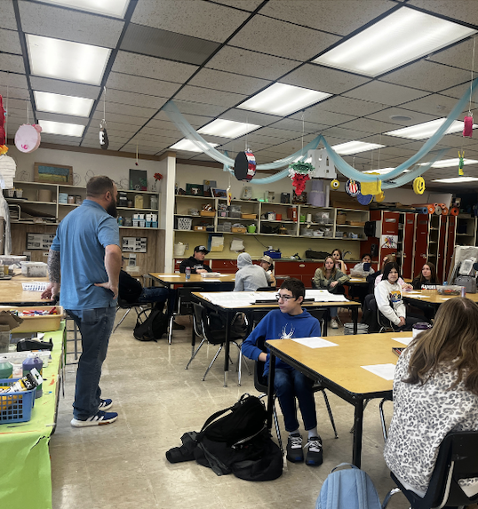 Aaron Fuller, of Fuller Designs, speaks to high school art students in the art classroom