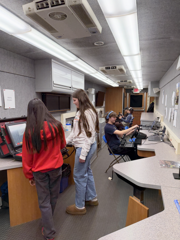 4 8th grade students get to try the simulators in the mobile lab