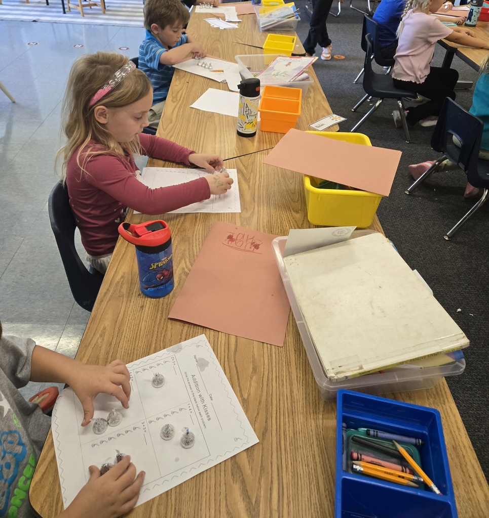 students working on sheets of paper with hershey kisses