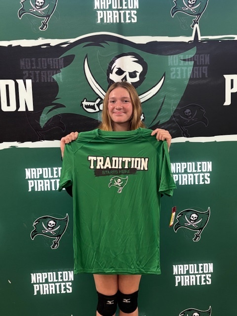 Hallie Duvall holding a #TraditionStartsHere t-shirt