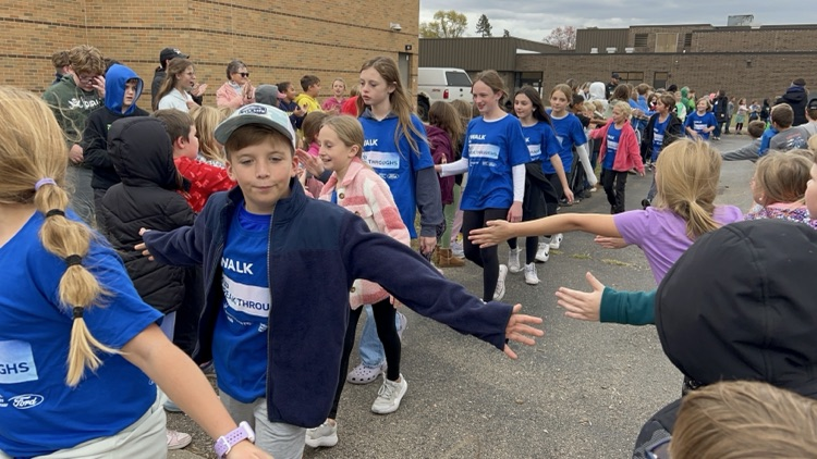 kids giving each other high fives on the track at school