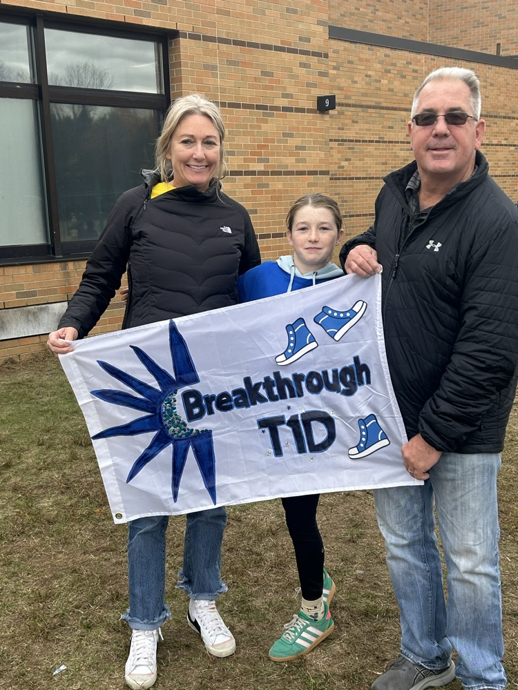 man, daughter, and woman holding T1D banner