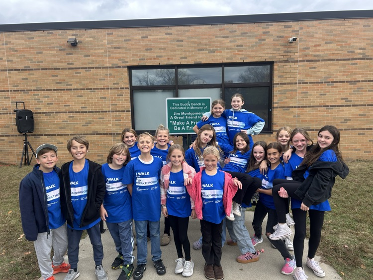 kids standing in a group in front of the school