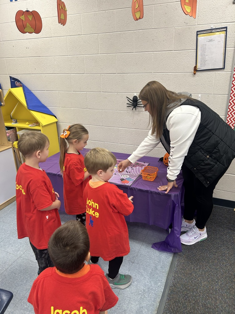 adult helping students with activity 