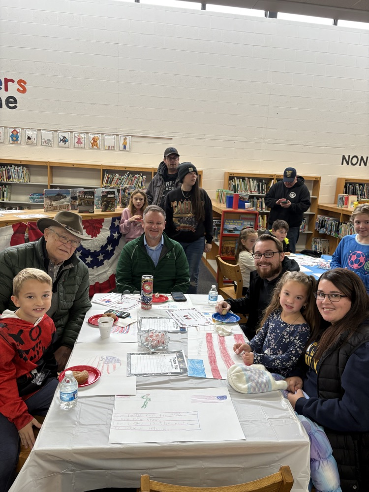 people sitting at a table celebrating Veterans Day