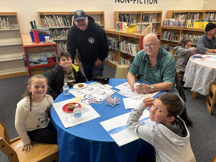 people sitting at table for Veterans day celebration 
