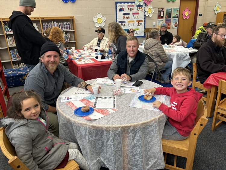 people sitting at table for Veterans day celebration 