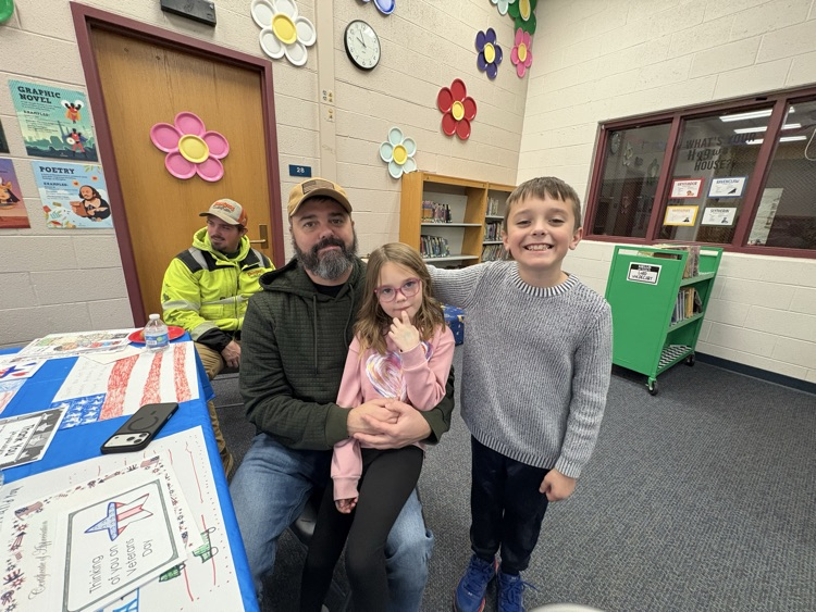 kids with father at veterans day celebration 
