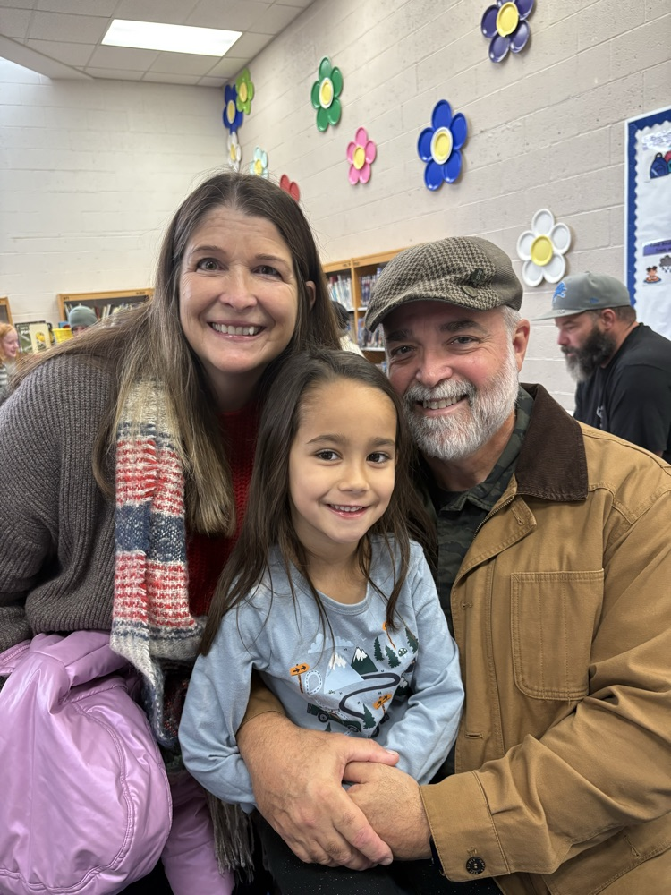 child with grandparents at Veterans day celebration 