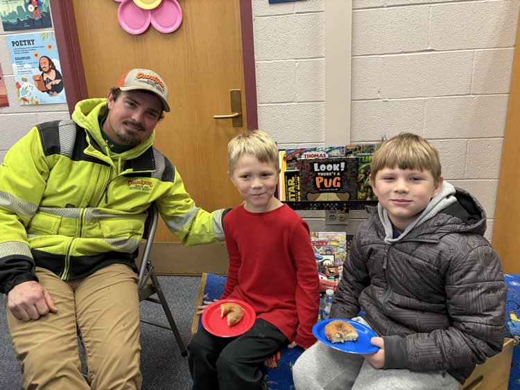two boys with their uncle celebrating Veterans day
