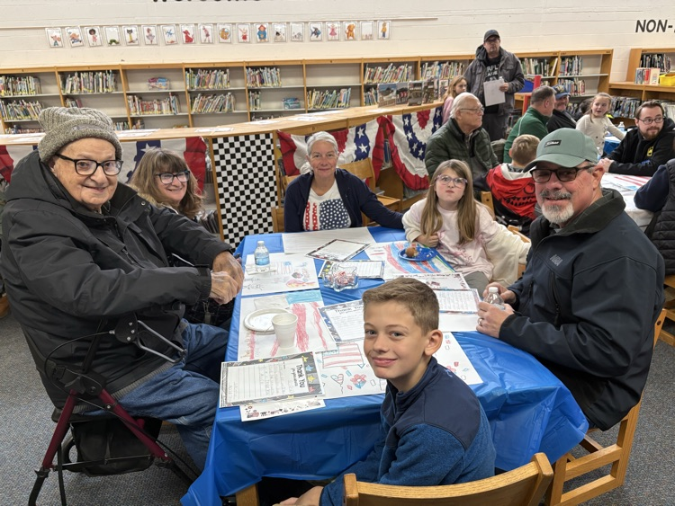 people sitting at table for Veterans day celebration 
