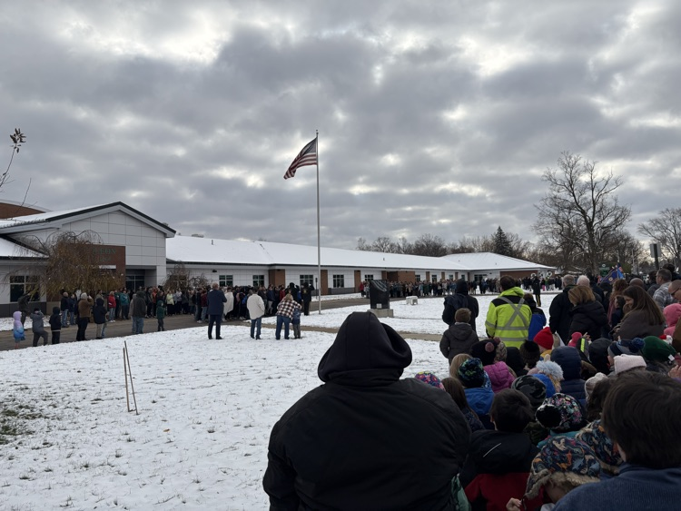 people standing at flag pole