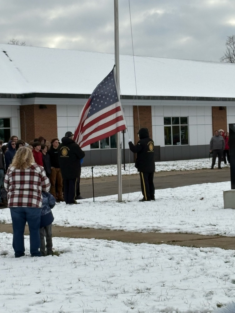 people raising the flag on Veterans day