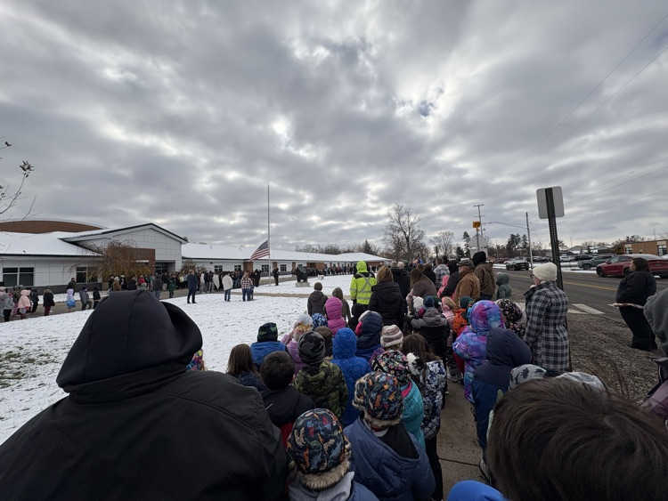 people standing at the flag pole